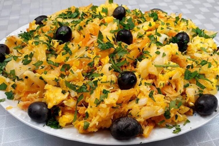 Refogado de cebola, alho e bacalhau desfiado em azeite de oliva, base para a receita de bacalhau à Brás.