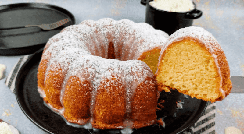 Bolo de leite quente fofinho e dourado, polvilhado com açúcar e canela
