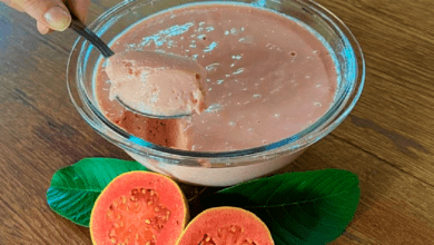 Taças de mousse de goiaba cremosa decoradas com pedaços de goiaba fresca e hortelã.