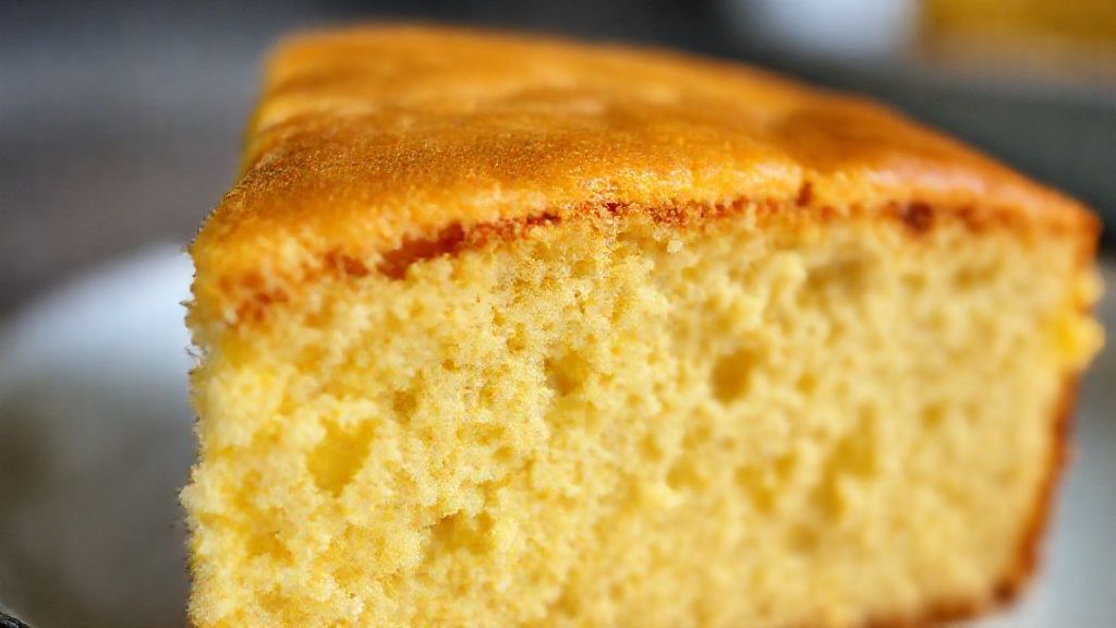 Close-up do bolo de fubá Pullman mostrando a textura fofa e o dourado perfeito