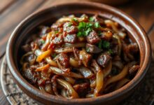 Carne seca acebolada com cebolas caramelizadas e salsinha fresca, pronta para servir.