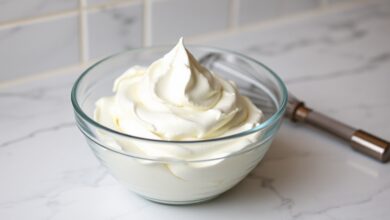 Tigela de vidro com chantilly branco, firme e brilhante, com picos que não tombam, pronto para uso.
